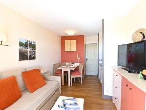 a living room with a couch and a table at Apartment Village Cap Estérel - Le Village-80 by Interhome in Agay - Saint Raphael