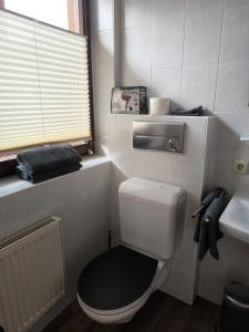 a small bathroom with a toilet and a sink at Ferienwohnung Fleur in Bad Kohlgrub