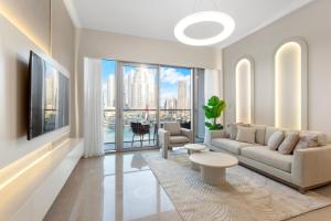 a living room with a couch and a large window at Elegant Retreat with Stunning Burj Khalifa Views in Dubai
