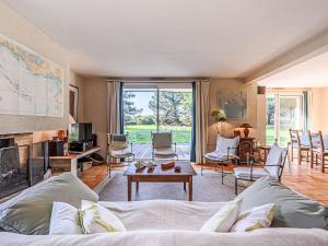 a living room with a couch and a fireplace at Holiday Home Le Prado-3 by Interhome in Saint-Philibert