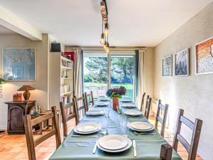 a dining room with a long table and chairs at Holiday Home Le Prado-3 by Interhome in Saint-Philibert