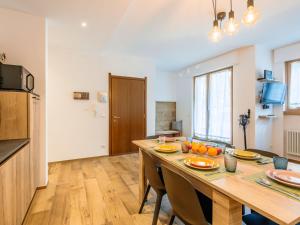 a kitchen with a large wooden table with oranges on it at Apartment Cesa del sass by Interhome in Alba di Canazei +42 photos