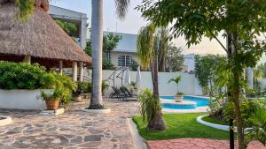 a resort with a swimming pool and palm trees at VILLAS EL ENCANTO in Jalpan de Serra