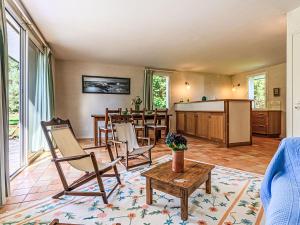 a living room with chairs and a table and a bar at Holiday Home Le Prado-2 by Interhome in Saint-Philibert +12 photos