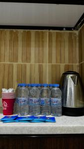 a group of bottles of water sitting on a counter at فندق جواهر الهدى in Makkah
