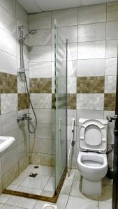 a bathroom with a shower and a toilet and a sink at فندق جواهر الهدى in Mecca +39 photos