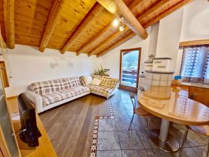 a living room with two couches and a table at Chalet Larsech by AMA Val di Fassa in Pera