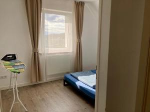a small bedroom with a bed and a window at Helle Ferienwohnung in Lichtenfels Schney in Lichtenfels