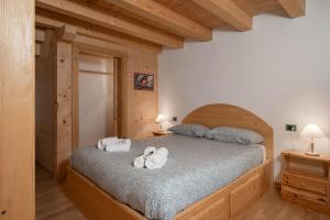 Postel nebo postele na pokoji v ubytování Albergo Diffuso Dolomiti