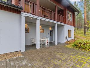 a house with a deck and a patio at Holiday Home Villa uuttu by Interhome in Pyhätunturi