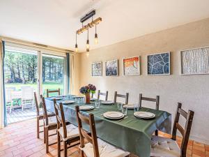 a dining room with a long table and chairs at Holiday Home Le Prado-1 by Interhome in Saint-Philibert