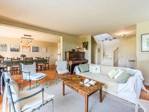a living room with a couch and a table at Holiday Home Le Prado-1 by Interhome in Saint-Philibert