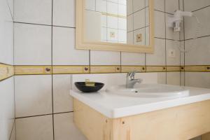 un baño con lavabo y espejo en Le Bel Vue, en Le Cergne