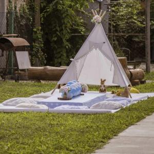 a teepee tent with a dog laying on a blanket at Vikendica Dar in Begeč