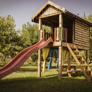 a playground with a slide and a play house at Vikendica Dar in Begeč
