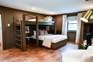 a bedroom with two bunk beds in a room at The Bidwell Bungalow in Amanda
