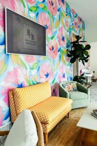 a living room with a couch and a colorful wall at The Bidwell Bungalow in Amanda +13 photos