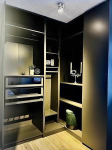 a walk in closet with black walls and wooden floors at Ferienwohnung Stern in Goslar