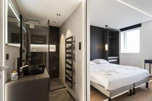 Postel nebo postele na pokoji v ubytování L'Esplanade