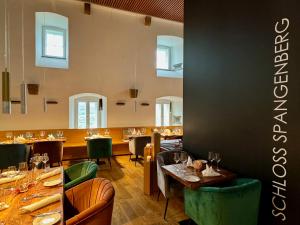 a dining room with tables and chairs and a restaurant at Schloss Spangenberg in Spangenberg
