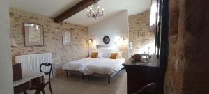 a bedroom with a bed and a table and a sink at Les Terrasses du Carlat, Le Logis, Demeure raffinée, situation idéale Dordogne, vues, piscine in Saint-Cybranet +40 photos