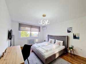 a bedroom with a bed and a table in it at Infinity Apartment & Free Wifi & Free Parking in Sarajevo