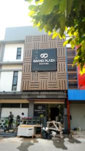 a building with a sign on the front of it at Grand Plaza Suites in Karawang