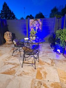 a table and chairs on a patio at night at O'Romantic in Arques