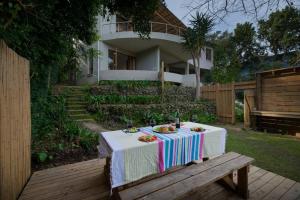a table with a plate of food sitting on a bench at Paradise Hideaway in Knysna