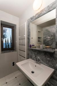 a bathroom with a sink and a mirror at LEONIDIONHOUSES - The Lykoskufi Villas in Tiros