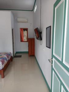 Postel nebo postele na pokoji v ubytování Tanah merah guest house