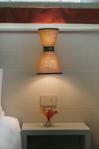 a lamp sitting on a table next to a bed at Sorapiana in Vidor