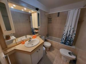 a bathroom with a sink and a toilet and a tub at Olivia Sunset 31 - One Bed in Puerto de Santiago +13 photos
