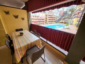a balcony with a table and a view of a pool at Olivia Sunset 31 - One Bed in Puerto de Santiago