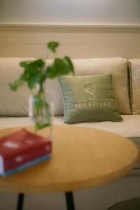a vase on a table with a pillow on a couch at Sorapiana in Vidor