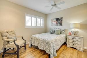 a bedroom with a bed and a chair and a ceiling fan at Hot Tub and Patio Family Gem in Avondale in Avondale +19 photos
