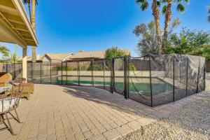a black fence with a pool in a backyard at Hot Tub and Patio Family Gem in Avondale in Avondale