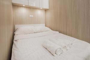 a bedroom with two beds with white sheets and towels at MIA Centrum Wrocław in Wrocław