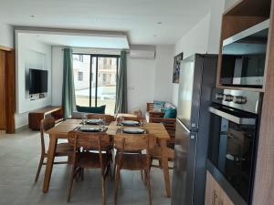 a kitchen and dining room with a table and chairs at Luxury Seaview Apartment Flic en Flac CFF07 in Flic-en-Flac