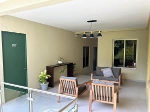 a living room with two chairs and a couch at Hotel Rimani in San Salvador +15 photos