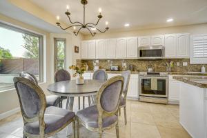 a dining room with a table and chairs in a kitchen at Hot Tub and Patio Family Gem in Avondale in Avondale