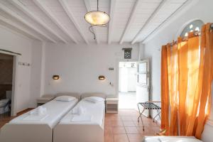 a living room with two white couches and a table at Apodrasi in Stení