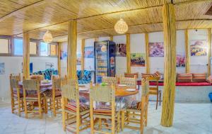 a dining room with a table and chairs at Dinosaur Anza Surf House in Agadir