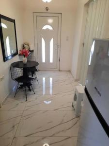 a hallway with a table and a white door at Tania's house in Tríkala