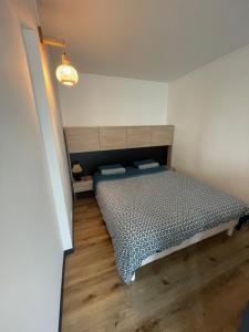 a bedroom with a bed with a wooden floor at Chez Joe, centre-ville in Verdun-sur-Meuse