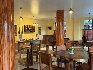 a restaurant with tables and chairs and a bar at Juanito's Resort in Tangalan