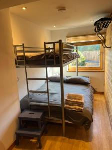 two bunk beds in a room with a window at Annexe Lodge cottage in Drymen in Drymen