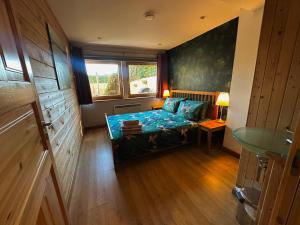 a small room with a bed and a window at Annexe Lodge cottage in Drymen in Drymen +5 photos