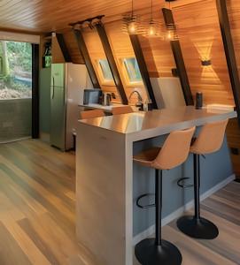 a kitchen with a island in a tiny house at Rosa Cabana de Canela in Canela