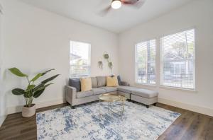 a living room with a couch and a table at 3BD Historic Charm x Modern Amenities w Hot Tub in Houston